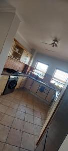 a kitchen with a sink and a stove in it at Priai Longa 34 Self Catering in Langstrand