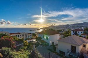a view of a city with houses and the ocean at Terrace Villa with Sea View in Santa Luzia