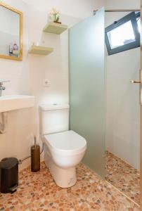 a bathroom with a toilet and a sink at Terrace Villa with Sea View in Santa Luzia