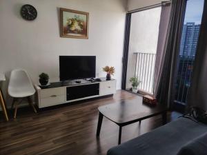 a living room with a tv and a couch and a table at Wonderful Geo Bukit Rimau Condominium in Shah Alam +11 photos