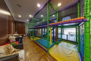 a room with a play room with a play structure at Hotel CROCUS in Štrbské Pleso