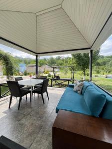 a living room with a blue couch and a table at Zeyvə Farm House 