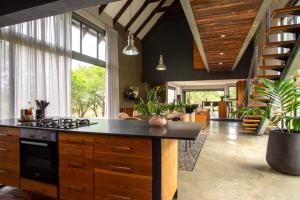 a large kitchen with a stove and a living room at House Nyala in Lydenburg