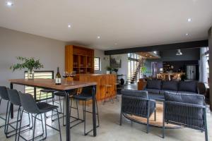 a living room with a table and chairs and a couch at House Nyala in Lydenburg +12 photos