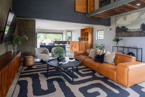 a living room with a couch and a table at House Nyala in Lydenburg