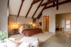 a bedroom with a large bed in a room at House Nyala in Lydenburg