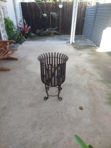 a garbage can sitting in a yard next to a fence at Turtle Creek - Ridleys in Umkomaas