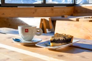 a piece of cake and a cup of coffee on a table at Wallackhaus hütte in Untertauern