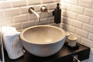 a bathroom with a bowl sink on a counter at Home Holidays - by MyHomeInComo in Argegno +18 photos