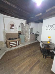 a living room with a table and a wooden floor at L' Arco Rosa in Alatri