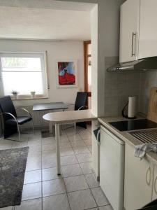 a kitchen with a table and some chairs and a table at Appartement Linda in Rheinfelden