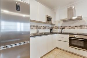 Kuchyň nebo kuchyňský kout v ubytování Apartamento Rolycar 103