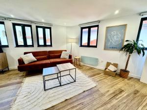 a living room with a couch and a table at Gestviva Casa Urbanin III in Cudillero
