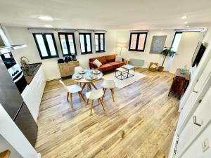 a living room with a table and a couch at Gestviva Casa Urbanin III in Cudillero