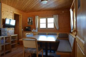 a dining room with a table and chairs and a window at Wallackhaus hütte in Untertauern