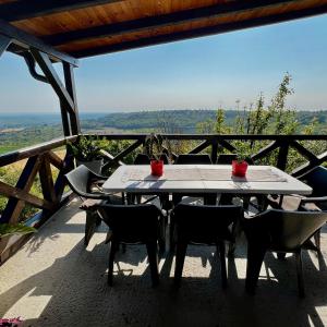 a table and chairs on a patio with a view at Pokito House on the Hill in Sremski Karlovci