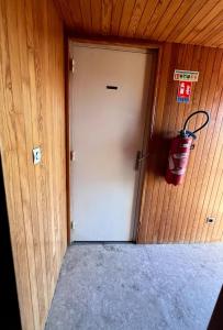 una puerta con una boca de incendios colgando de la pared en Hôtel de Bruay la buissiere, en Bruay-la-Buissiere