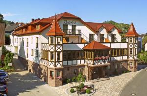 a large white building with red roofs on a street at Hotel Rebstock in Baden-Baden +82 photos