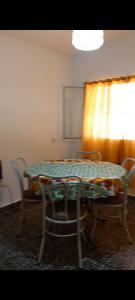 a room with a table and chairs and a window at Departamento Dai in Jesús María