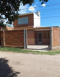 a fence in front of a brick building at Departamento Dai in Jesús María