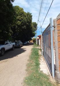a fence on the side of a road next to a house at Departamento Dai in Jesús María
