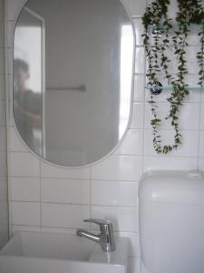 a bathroom with a mirror and a sink at Villa Amari - A Sunny Tranquil Home in Melbourne +20 photos
