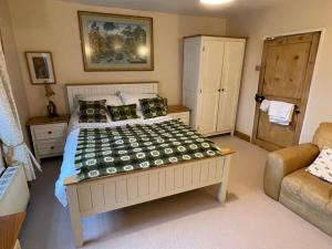 a bedroom with a large bed and a couch at Chateau Terrace Georgian House in Chepstow