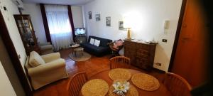a living room with a table and chairs and a couch at Incoming in ROME in Acilia