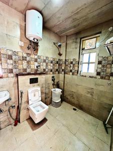 a bathroom with a toilet and a sink at Decent Stays in Shimla +20 photos