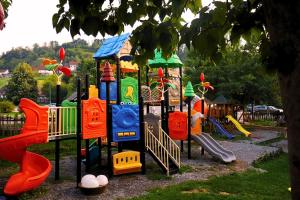 a playground with colorful play equipment in a park at Restoran,,Vuk,, Tršić in TrÅ¡iÄ‡