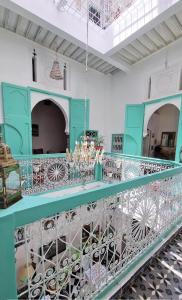 a room with a blue counter with chandeliers at Riad Nostalgie of Tetouan in Tetouan