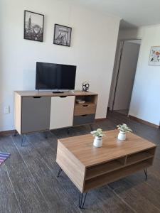 ドゥラスノにあるCasa bellaのテレビとコーヒーテーブルのあるリビングルーム