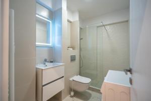 a bathroom with a toilet and a sink and a shower at Elegant Ivory Studio by Blvd 16B7 - Quiet Garden View in Pipera in Pipera