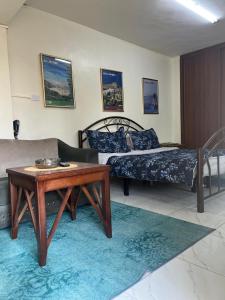 a living room with two beds and a coffee table at Sami Apartments in Amman