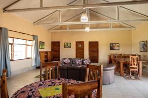 a living room with a couch and a table at Rain Tree Camp in Chunga