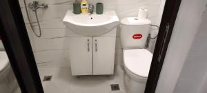 a bathroom with a toilet and a sink at Studio 6-2 Hristo Stanechev 2- Dental University in Bŭnzareto +14 photos