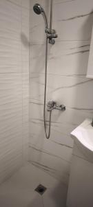 a shower in a white bathroom with a sink at Studio 6-2 Hristo Stanechev 2- Dental University in Bŭnzareto