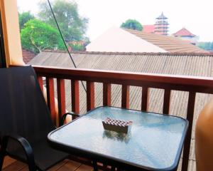 a glass table on a balcony with a chess board on it at apartement Puri 2 in Jimbaran
