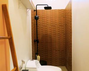 a bathroom with a toilet and a brick shower at apartement Puri 2 in Jimbaran +9 photos