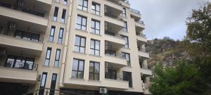 a tall white building with balconies on it at Studio 6-2 Hristo Stanechev 2- Dental University in Bŭnzareto