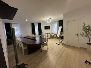 a living room with a table and a dining room at Turnul ALB in Costeşti