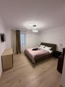 a bedroom with a bed and a table in it at Turnul ALB in Costeşti