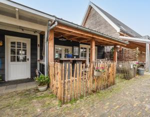 a wooden fence in front of a house at Ride by the Sea Guesthouse in Koudekerke