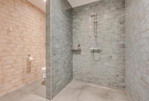 a bathroom with a shower and a toilet at Ride by the Sea Guesthouse in Koudekerke