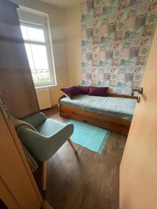 a living room with a couch and a window at Aqua Apartman in Pécs