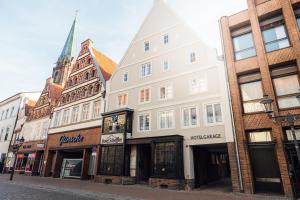 a group of buildings on a city street at Hotel Scheffler Lüneburg in Lüneburg