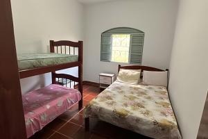 a bedroom with two bunk beds and a window at Casa Alpe de Itapeva in Itapeva +19 photos
