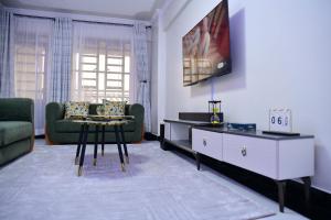 a living room with a couch and a table at Araka Homes in Nakuru