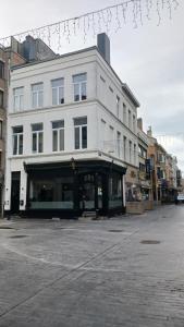 a large white building on a city street at Suite Blanche in Ostend