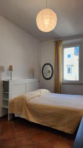 a bedroom with a large bed and a window at Alloggio all’Ombra del Campanile in Riano